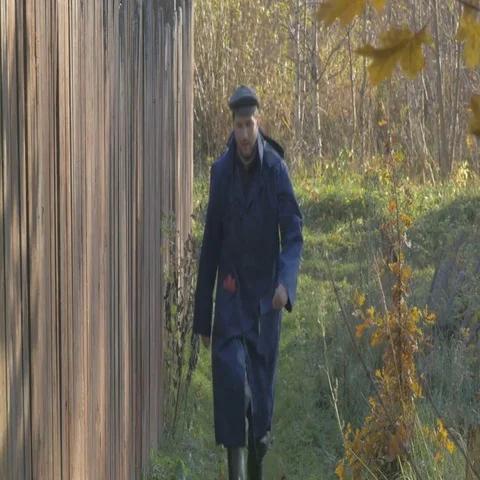One man, walking along the road in the village at autumn day. Shallow focus Video stock 69709020