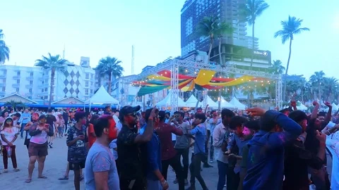 One of the men in the crowd has red paint on his face at the traditional Holi Stock Footage 334119972