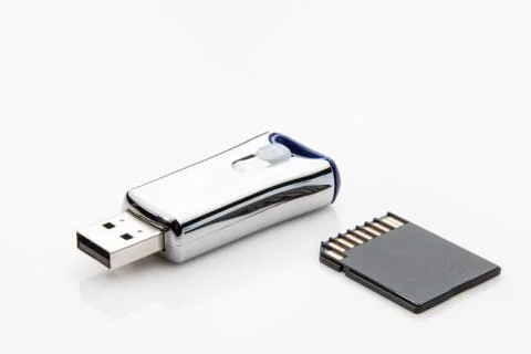 One Micro sd card and one USB flash drive on white background. Stock Photos