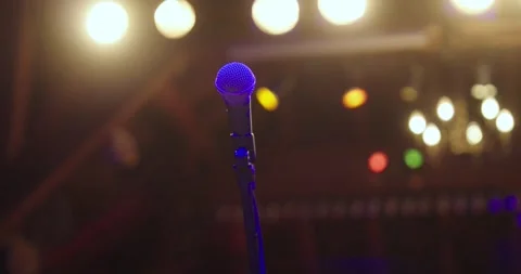 One microphone on stage with stage lights without people, open mic Stock Footage 305138428