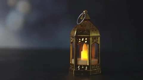 One mini golden miniature Moroccan lantern with LED candle on dark background. Stock Footage 328553286