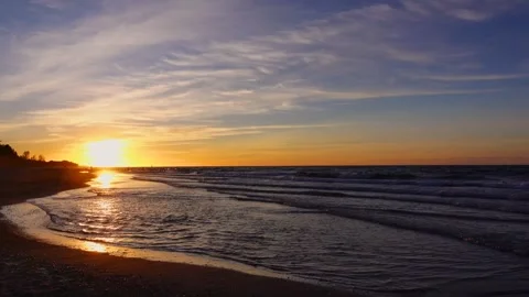 One minute 4K loop golden sunset over ocean beach with calm sea waves ambient Video stock 347199324