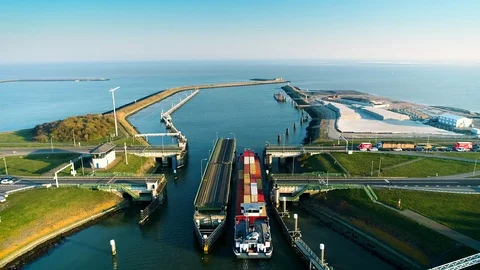[One Minute] Large Cargo Ship Crossing Bridge - Friesland, Holland – 4K Drone Stock Footage 127576408