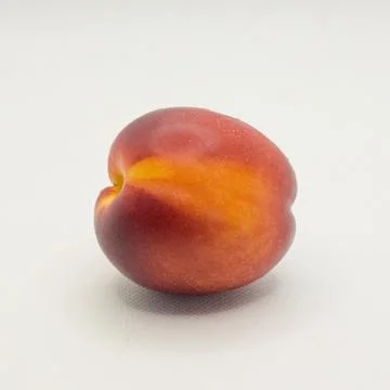 One nectarine on a white background Stock Photos