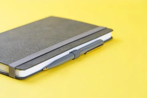 One notebook or diary on trendy yellow background Stock Photos