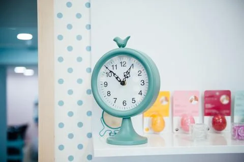 One o'clock on the blue wall clocks Stock Photos