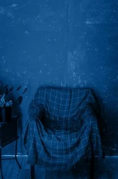 One old arm chair covered with checkered plaid Stock Photos