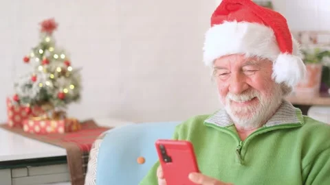 One old man enjoying and celebrating Christmas night at home alone sitting on th Stock Footage 166244976