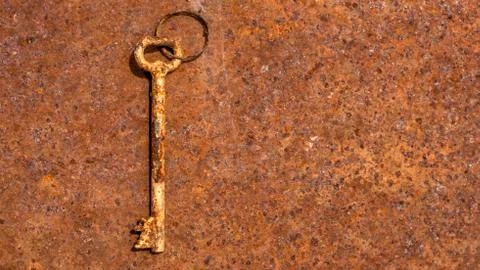 One old rusty keys on ring shot on steel textured background. Copy space. Stock Photos
