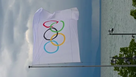 One Olympic flag beside Lake Geneva on cloudy day in Switzerland. Stock Footage 336703134