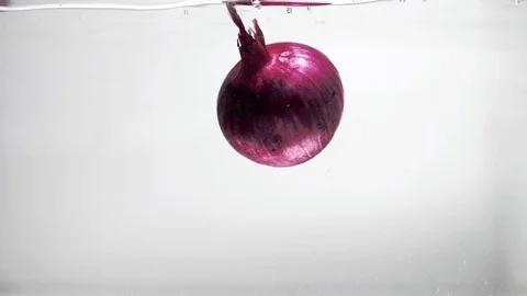 One onion spinning on a white background Stock Footage 102651361