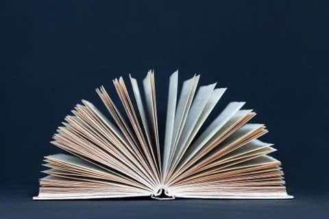 One open book on dark background Stock Photos