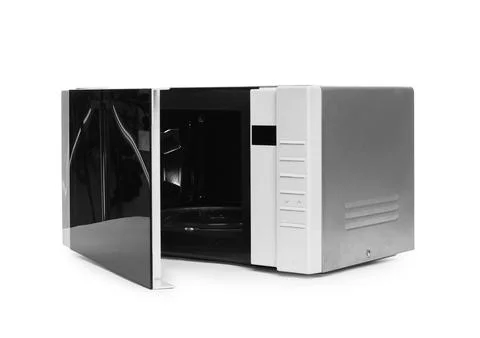 One open microwave oven isolated on white Stock Photos