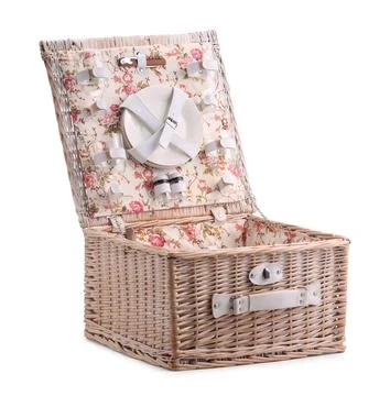 One open picnic basket with tableware isolated on white Stock Photos