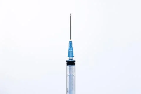 One open plastic disposable injection syringe on a white background Stock Photos
