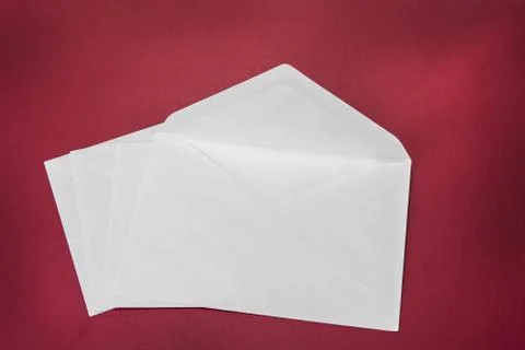One opened white envelope on the red background Stock Photos