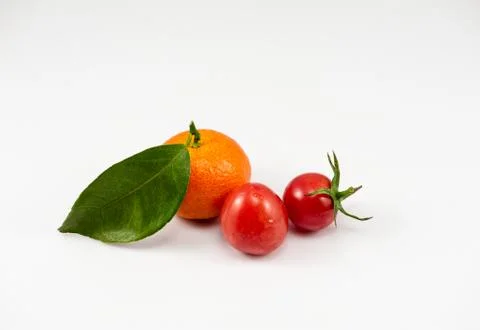 One orange and two tomatoes on the white background Foto stock