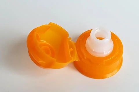 One orange cap from soft drink bottle on white background Stock Photos