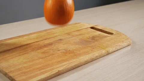 One orange fall on the kitchen table in slow motion and bounce close-up Stock Footage 113069273