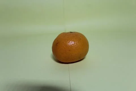 One orange on light green background Stock Photos