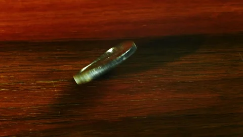 One ounce maple leaf silver coin spins on the table in slow motion Stock Footage 313633544