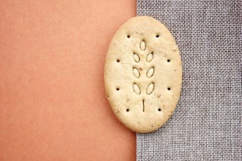 One oval multigrain biscuits on canvas closeup Stock Photos