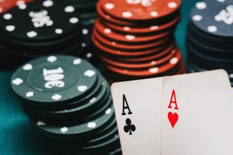 One pair of aces and playing chips in a game of poker Stock Photos