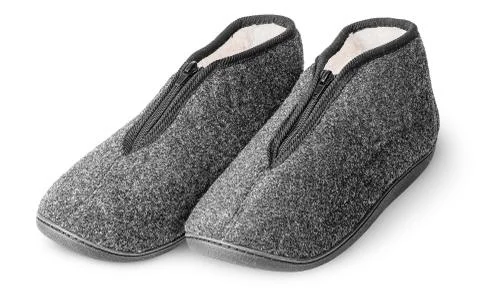 One pair comfortable dark gray slippers with fur Stock Photos