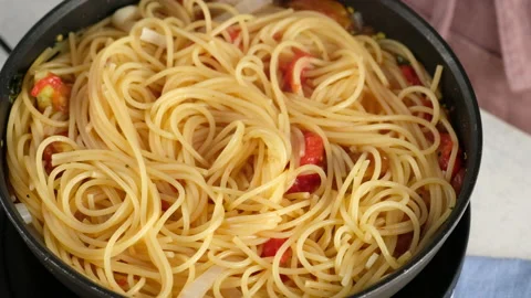 ONE PAN PASTA. Close-up shot of a female chef a pan cooking a pasta dish and Stock Footage 143728815
