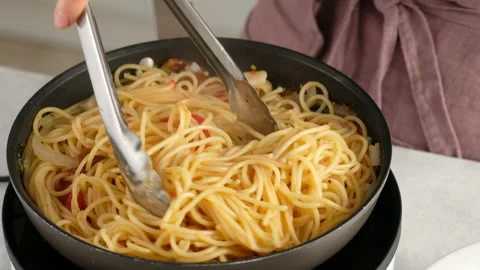 ONE PAN PASTA. Close-up shot of a female chef a pan cooking a pasta dish and Stock Footage 145091206