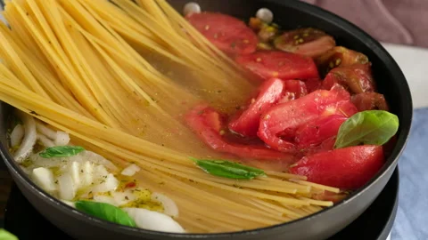 ONE PAN PASTA. Close-up shot of a female chef a pan cooking a pasta dish and Stock Footage 145091479