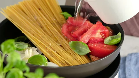 ONE PAN PASTA. Close-up shot of a female chef a pan cooking a pasta dish and Stock Footage 147045851