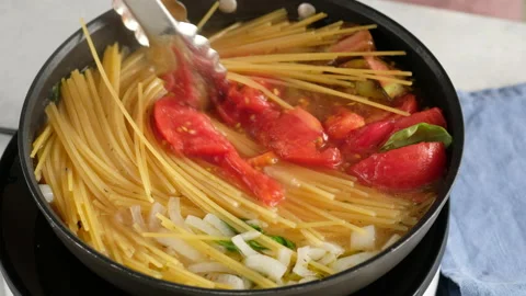 ONE PAN PASTA. Close-up shot of a female chef a pan cooking a pasta dish and Stock Footage 147045913