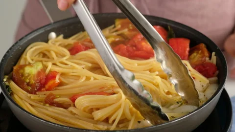 ONE PAN PASTA. Close-up shot of a female chef a pan cooking a pasta dish and Stock Footage 147047079