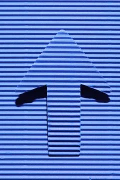 One paper arrow on blue background, top view Stock Photos