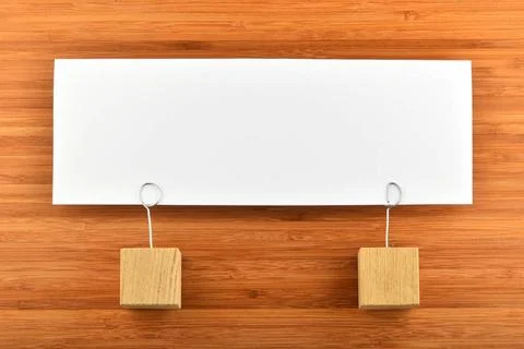 One paper note with two holders isolated on wooden background Together, on... Stock Photos