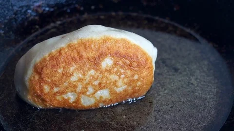 One Patty while frying in the pan, turn with a fork Stock Footage 72767250