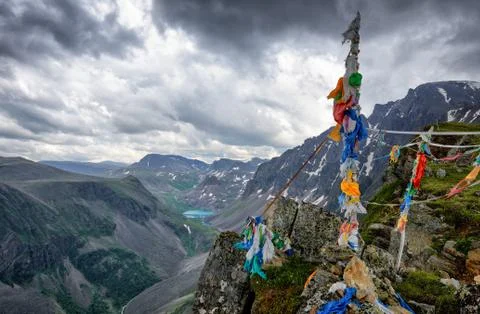 One of peaks of mountain range in Eastern Sayan. Numerous ribbons tied to alp Stock Photos