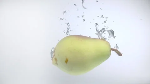 One pear fall into the water with splashes and bubbles in slow motion. Stock Footage 144486389