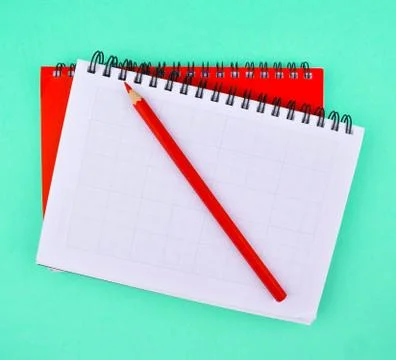 One pencil placed on two different color note paper diary placed on top of ea Stock Photos