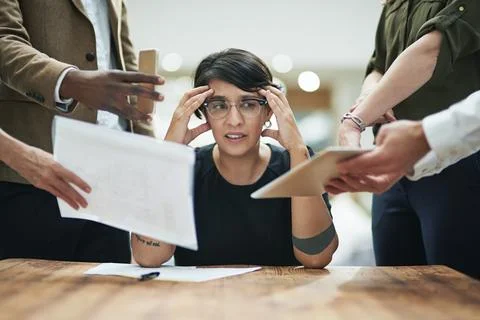 One person can only do so much. a young businesswoman feeling overwhelmed by her Stock Photos