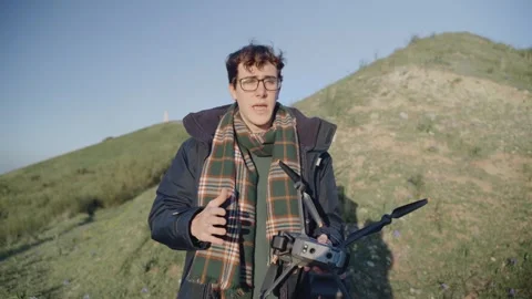One person explaining something with his drone handled in a landscape. Stock Footage 240397967
