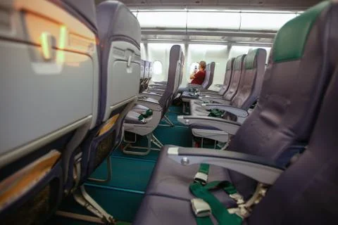 One person inside empty plane. Airlines crisis during coronavirus covid pandemic Stock Photos