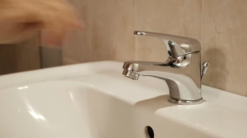One person opens and closes the water tap Видео 123876796