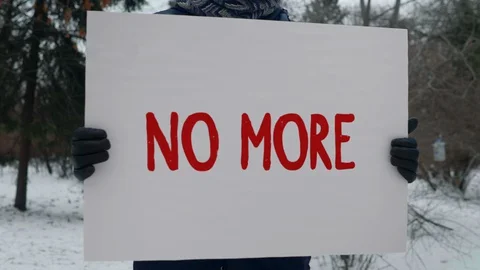 One Person Protest Man Stands in the Park With Big White Poster NO MORE Close Up Stock Footage 128003345