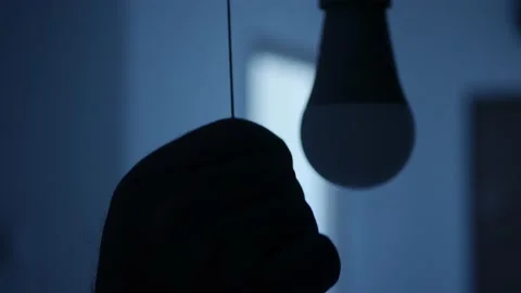 One Person Pull the Switch Cord Turning On the LED Light Bulb in the Office. Stock Footage 154197448