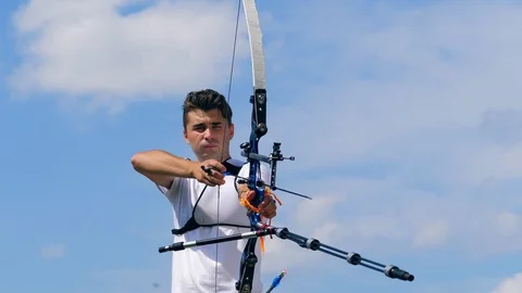 One person pulls an arrow in a bow on a shooting range. 動画素材 114968242