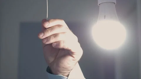 One Person Pulls the Switch Cord Turning On the Light in a Room.  Vídeo Stock 219306794