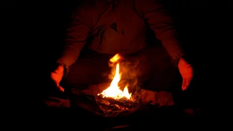 One Person Sitting Close to the Fire Stock Footage 97180938