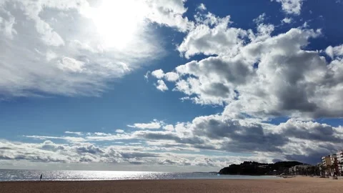 One person walking on an empty spanish beach with cloudy stormy sky, 4K Stock Footage 273171463